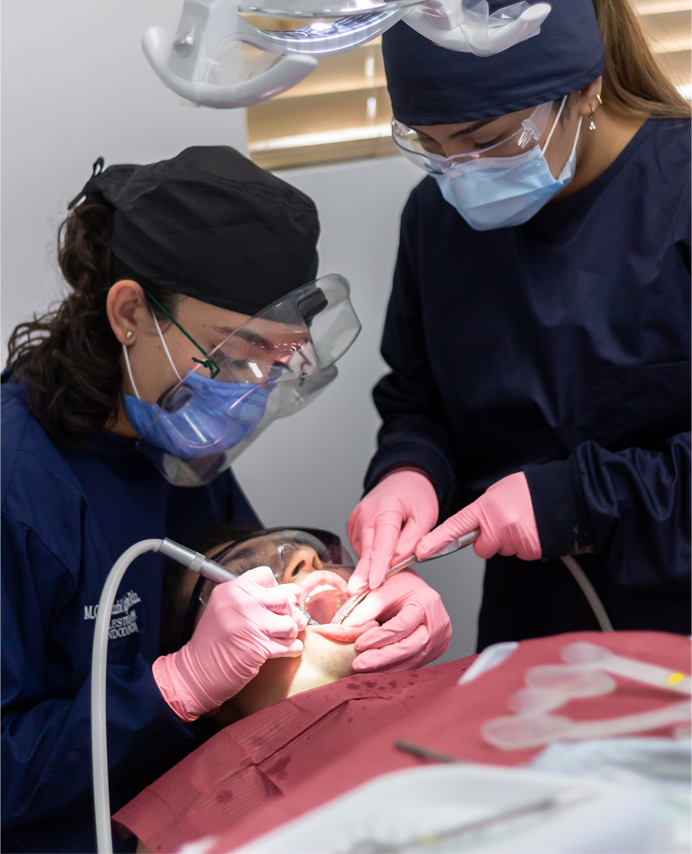 Two dentists performing an operation on a patient
