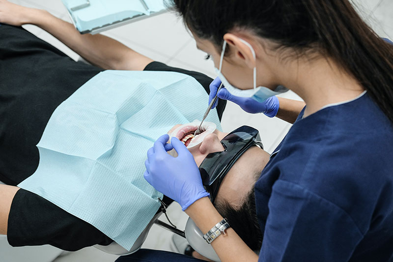 Dentist performing a dental endodontics treatment on a patient