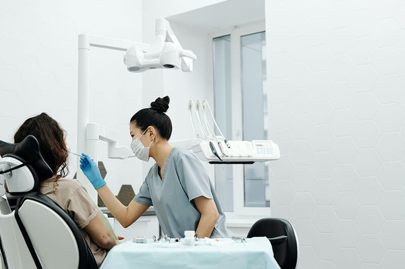 Dentist performing a dental service to a patient