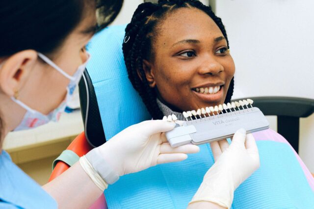 Dentist with patient checking dental prosthesis