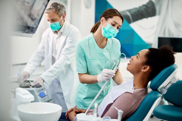Dentist in México border;assistant and dentist running a dental process