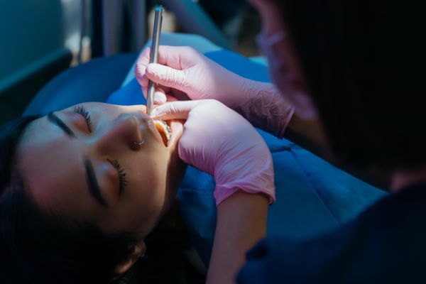 Los Algodones dentist prices; dentist checking teeth patient